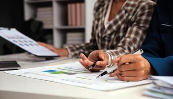 Group of confident business people point to graphs and charts to analyze market data, balance sheet, account, net profit to plan new sales strategies to increase production capacity. photo