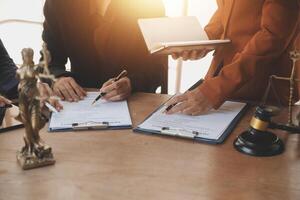 Lawyer, legal advisor, businessman brainstorming information on agreement details Business contracts in legal processing books for accuracy in contract documents. joint financial investment. photo