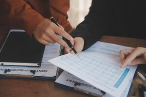 Lawyer, legal advisor, businessman brainstorming information on agreement details Business contracts in legal processing books for accuracy in contract documents. joint financial investment. photo