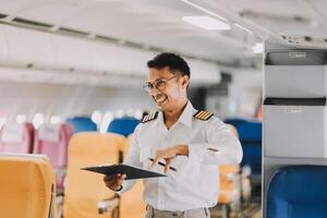 Portrait of a trained airplane captain in uniform preparing to fly in a simulator cockpit. photo