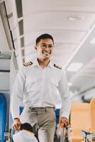 Portrait of a trained airplane captain in uniform preparing to fly in a simulator cockpit. photo