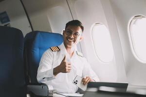 Portrait of a trained airplane captain in uniform preparing to fly in a simulator cockpit. photo
