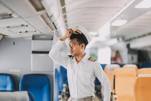 Portrait of a trained airplane captain in uniform preparing to fly in a simulator cockpit. photo