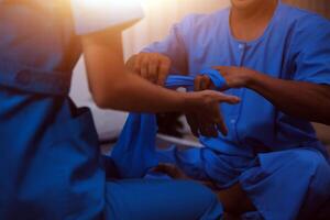 Professional physical therapist examines and cares for a young man in a physical therapy center, treating muscles and injuries of a man in a hospital. photo