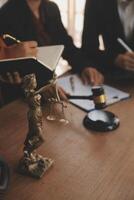 Lawyer, legal advisor, businessman brainstorming information on agreement details Business contracts in legal processing books for accuracy in contract documents. joint financial investment. photo