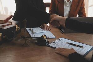 concept of justice and law A male judge in the courtroom on a wooden table and a male counselor or lawyer working in the office. Law, advice and justice concepts. photo