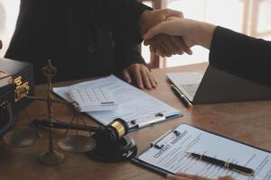 concept of justice and law A male judge in the courtroom on a wooden table and a male counselor or lawyer working in the office. Law, advice and justice concepts. photo