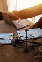 concept of justice and law A male judge in the courtroom on a wooden table and a male counselor or lawyer working in the office. Law, advice and justice concepts. photo