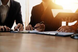 Lawyer, legal advisor, businessman brainstorming information on agreement details Business contracts in legal processing books for accuracy in contract documents. joint financial investment. photo