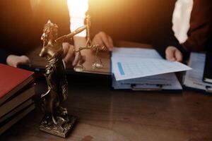 Lawyer, legal advisor, businessman brainstorming information on agreement details Business contracts in legal processing books for accuracy in contract documents. joint financial investment. photo