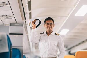 Portrait of a trained airplane captain in uniform preparing to fly in a simulator cockpit. photo