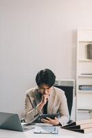 Frustrated Asian young businessman worker working on table in office. Busy employee worker people feel tired and headache from late work and overwork job document on computer desk at company workplace photo