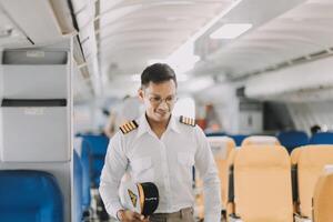 Portrait of a trained airplane captain in uniform preparing to fly in a simulator cockpit. photo