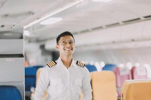 Portrait of a trained airplane captain in uniform preparing to fly in a simulator cockpit. photo