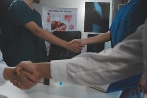 Doctor handshake and partnership in healthcare, medicine or trust for collaboration, unity or support.Team of medical experts shaking hands in teamwork for or success in hospital photo