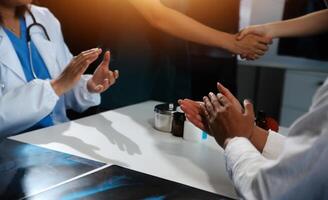 Doctor handshake and partnership in healthcare, medicine or trust for collaboration, unity or support.Team of medical experts shaking hands in teamwork for or success in hospital photo