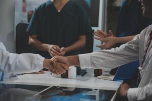 Doctor handshake and partnership in healthcare, medicine or trust for collaboration, unity or support.Team of medical experts shaking hands in teamwork for or success in hospital photo