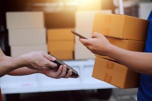 Asian delivery express courier young man use giving boxes to woman customer he wearing protective face mask at front home photo