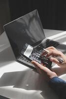 businessman working on desk office with using a calculator to calculate the numbers, finance accounting concept photo