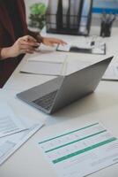 Cropped image of professional businesswoman working at her office via laptop, young female manager using portable computer device while sitting at modern loft, flare light, work process concept photo