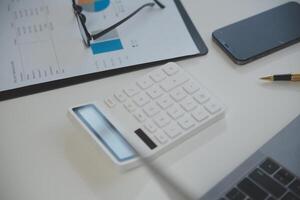 Laptop computer with opened lid on table in meeting room of office workspace. photo