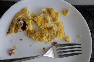 Omelet with ham on white plate photo