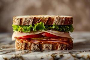 Sandwich with beef, cheese, tomato and lettuce on a marble background photo