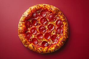 Pepperoni pizza on red background, top view, copy space photo