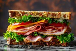 Sandwich with beef, cheese, tomato and lettuce on a marble background photo