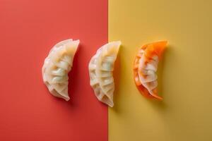 Japanese gyoza dumplings on red and yellow background, top view photo