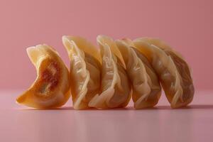 Japanese gyoza dumplings on pink background photo