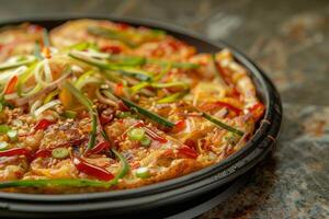 Pajeon with herbs and spices on a black plate. Close-up photo