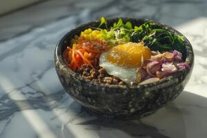 Bibimbap with rice, vegetables and egg in bowl photo