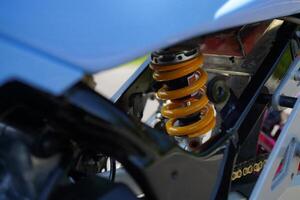 close up of monoshock spare parts from the 4-Stroke underbone motorbike category, yellow pear. photo