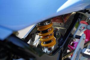 close up of monoshock spare parts from the 4-Stroke underbone motorbike category, yellow pear. photo