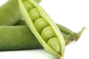 Fresh green peas in a pod on a white background photo