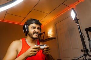 Professional game player holding a joystick playing with a console. photo