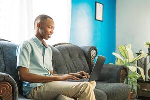 young man using a computer at home. photo