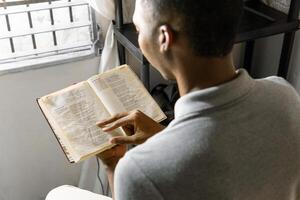 Man relaxing and reading a book. photo