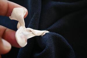Detailed instructions for effectively removing chewing gum from fabric, with closeup view focus photo