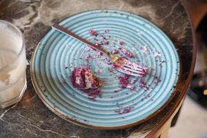 An empty dirty plate with a fork. photo