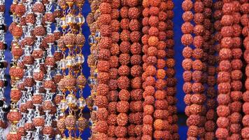 Bead chains used for spiritual and cultural purposes displayed in a shop photo