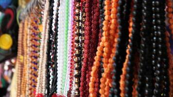 Colorful decorative pearl chains displayed in a shop photo