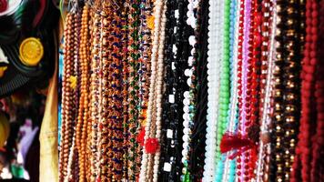 Colorful decorative pearl chains displayed in a shop photo