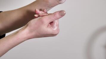 washing woman's hands with soap and water to remove dirt and germs close-up on white background. The fingers move gently and slowly video