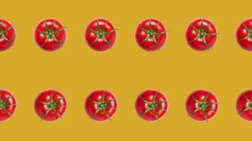 Bright red tomatoes arranged in a rotating pattern on a mustard yellow background, ideal for summer, gardening, and Mediterranean cuisine concepts video