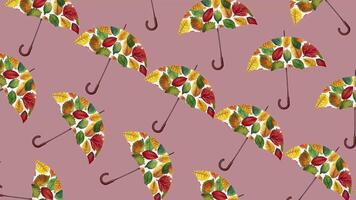 A repeated pattern of autumn leaf decorated umbrellas on a mauve background, suitable for seasonal themes like fall and Thanksgiving decor video
