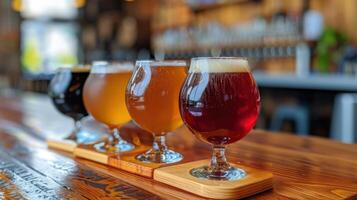 A variety of craft beers served in different glasses on a wooden table, showcasing a range of colors and types. photo