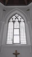 View inside of a white chapel with the cross crucifixion on the wall. Action. Concept of architecture and religion. video