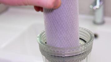 Plumber or repairman puts a new pure carbon water filter in the bathroom. Replacement of the filter in the water purification filter video